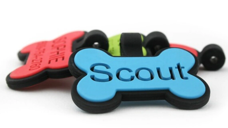 Blue dog tag labeled 'Scout' in bone shape.