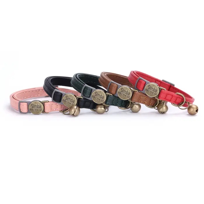 Colorful pet collars with bells displayed in a row.