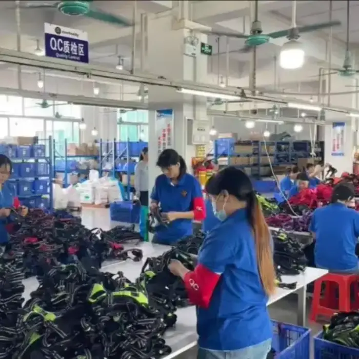 Workers inspecting products in a factory quality control area.
