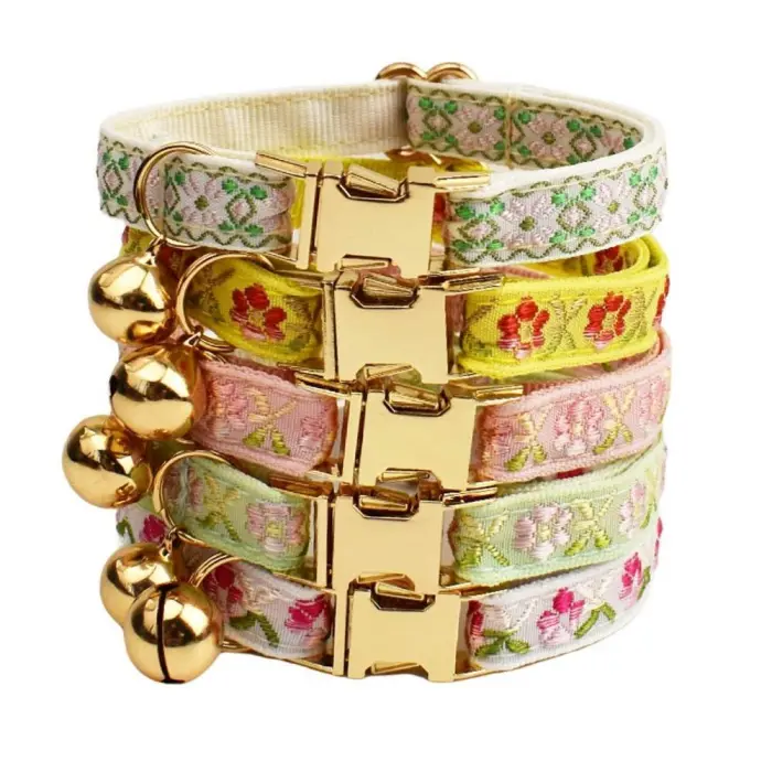 Stack of embroidered cat collars with bells
