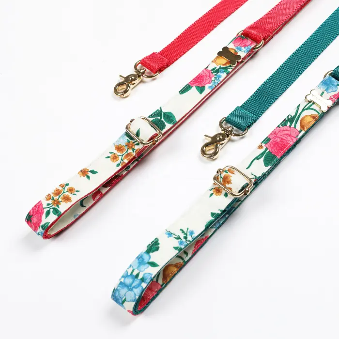 Colorful floral dog leashes on white background.
