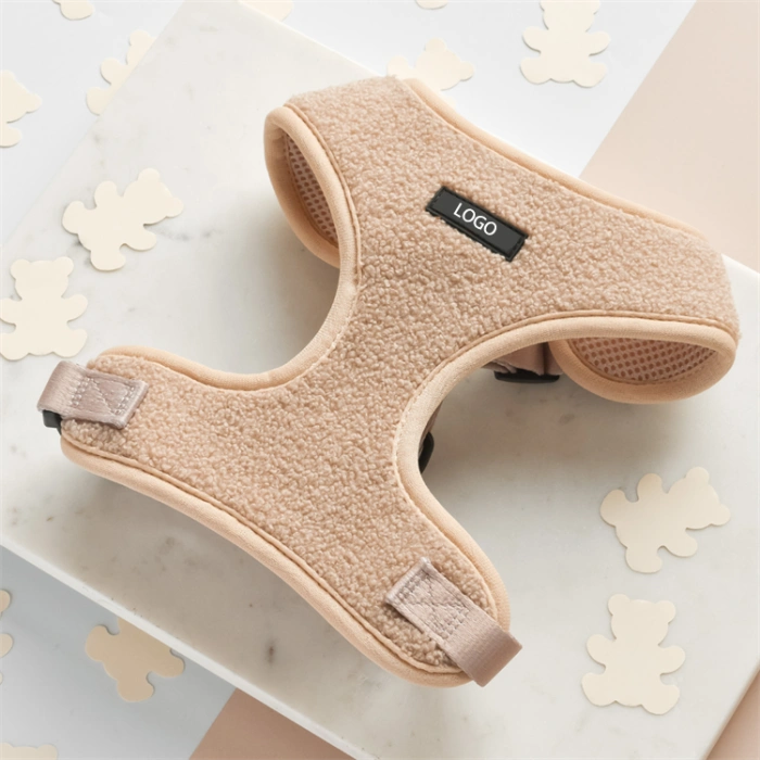 Beige dog harness on decorated marble surface.
